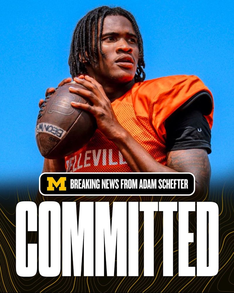 Bryce Underwood, the number one college football prospect for 2025, holding a football in a throwing stance, wearing an orange practice jersey with the word ‘Belleville’ partially visible. The image includes a graphic overlay with the University of Michigan logo, the text ‘Breaking News from Adam Schefter,’ and the word ‘COMMITTED’ in large bold letters at the bottom against a black and yellow design background.