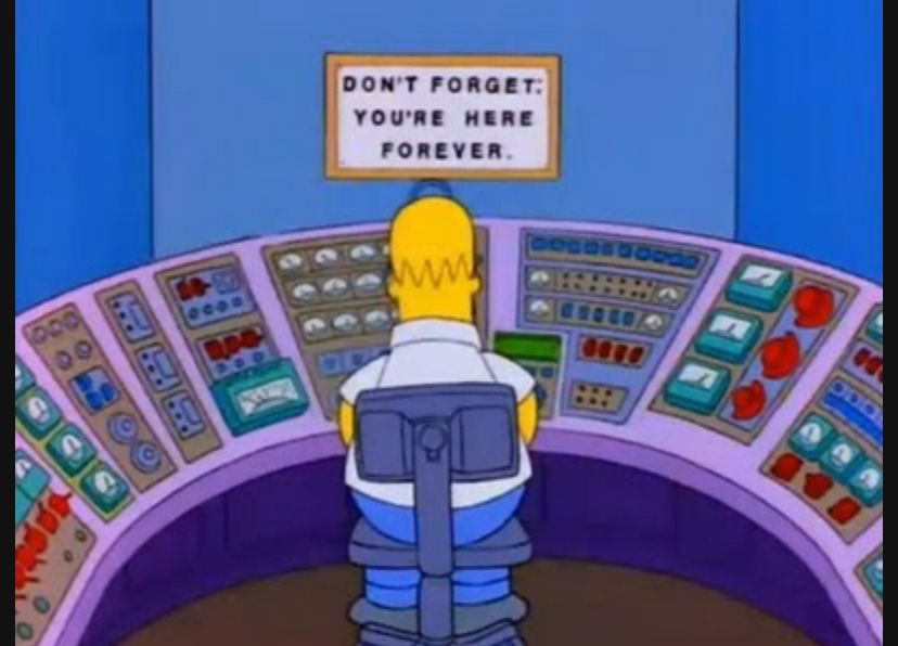 Mr. Burns taunts Homer with a Don’t Forget: You’re Here Forever sign at his workstation.