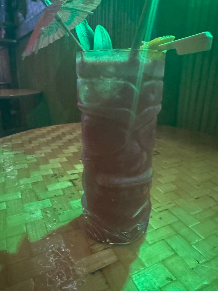 Bright red cocktail in tiki glass 