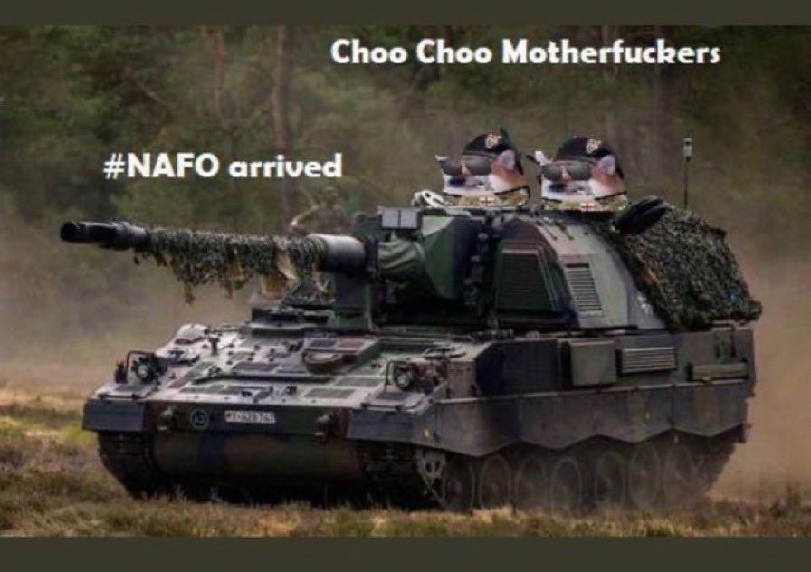 Photo of a tank with Shiba Inu dogs with army berets riding on top of it. The dogs are saying, “Choi choo motherfuckers” with the hashtag #NAFO arrived
