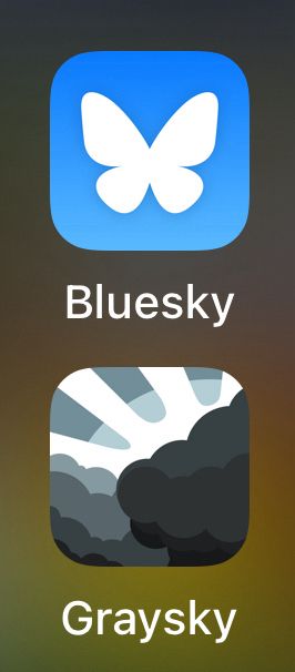 Bluesky app icon (a medium blue with a white butterfly outline inside the blue) and the Graysky icon (multiple overlapping and different shades of grey clouds with grey sunbeams and a light halo around the biggest and darkest cloud)