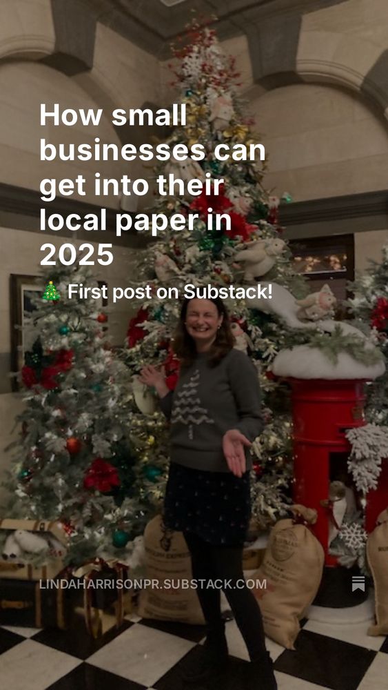 Image of Linda standing in front of a number of Christmas trees.