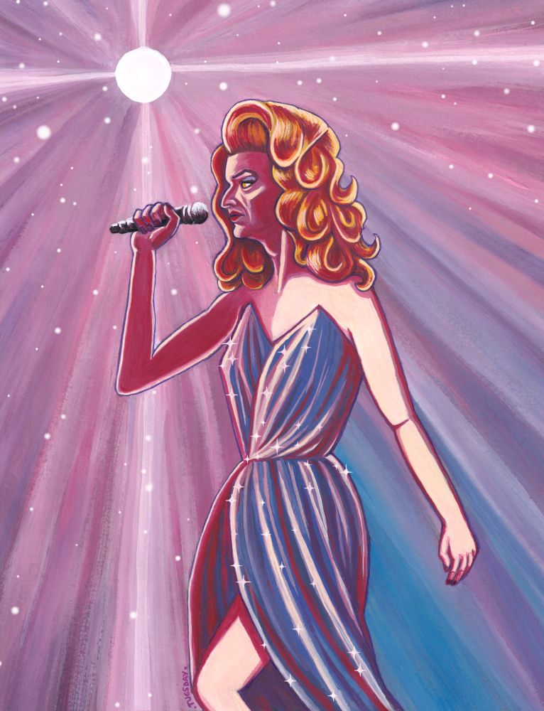 Drag queen Crowley holding a microphone, standing in front of bright stage lights that look like stars. Her dress in blue and sparkly. 