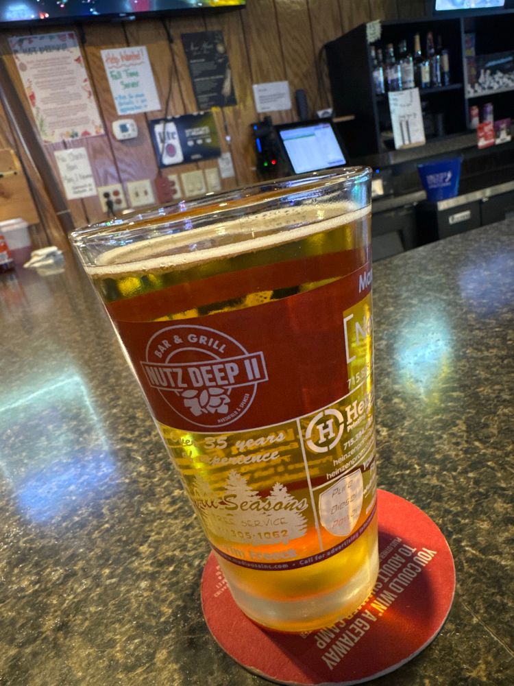 Pint of beer (US) depicting a logo that reads “Nutz Deep II” 