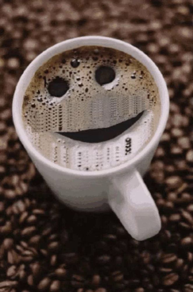 a cup of coffee with a smiley face on top