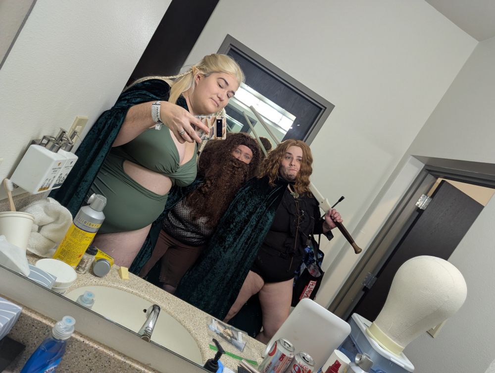 Three people dressed up as lord of the rings but in swim suits. Characters include Aragorn, Gimli, and Legolas 