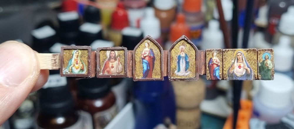 A couple of miniature religious icons, made from 3D printed frames, and nail stickers. 