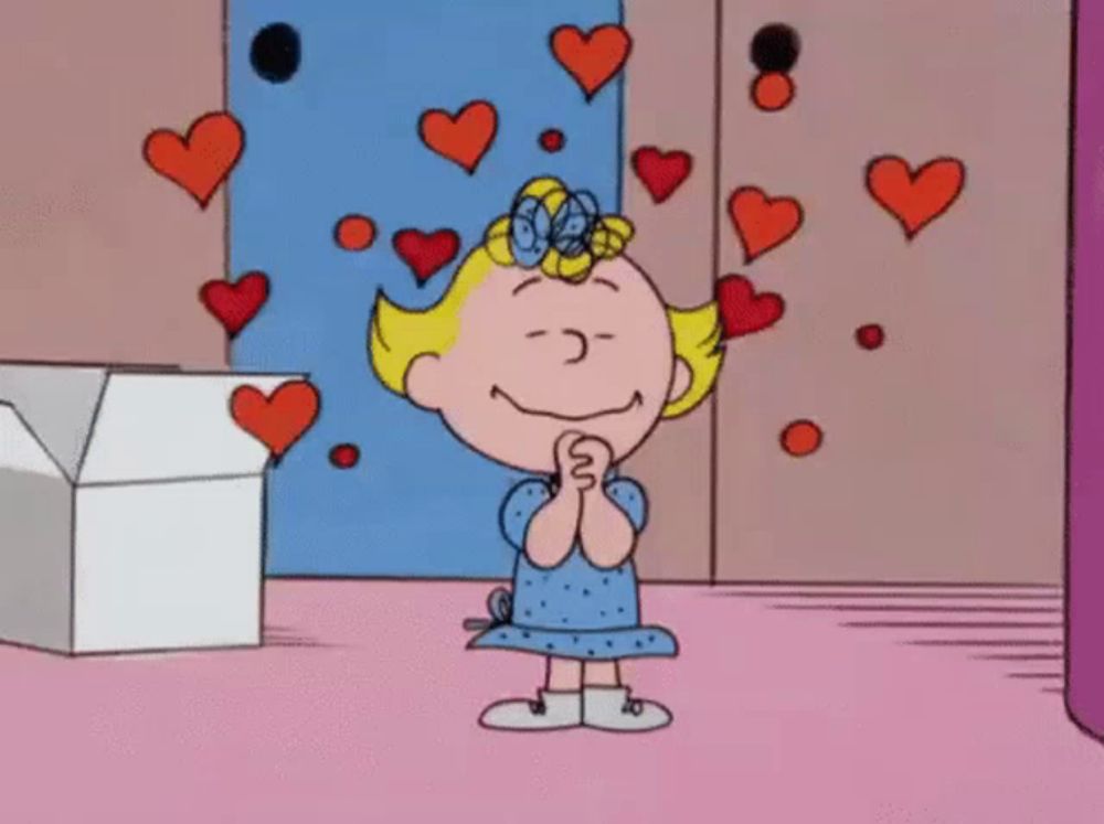 a cartoon girl is surrounded by hearts on a pink background .