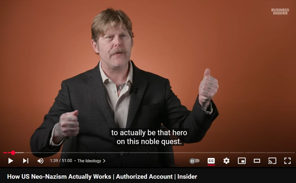 A screenshot from a youtube video called "How US Neo-Nazism Actually Works", where a man explains how he was drawn to nazism as a young man because it made him feel like a hero in a fantasy story