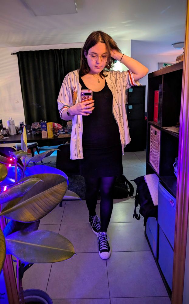 me wearing a white baseball shirt thingy over a black tanktop and pencil skirt combo with tights and converse shoes