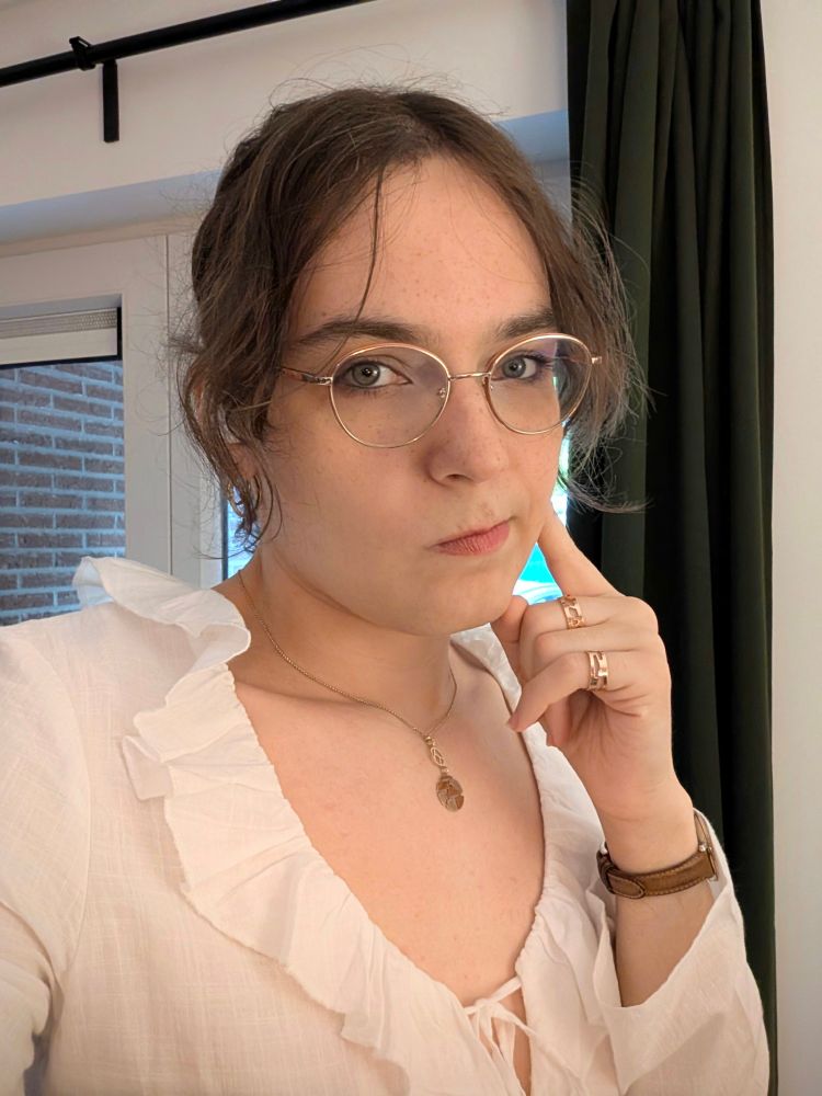 selfie where I'm wearing a white tied shirt type of top with a creased folded neckline that creates a weird silhouette around my chest