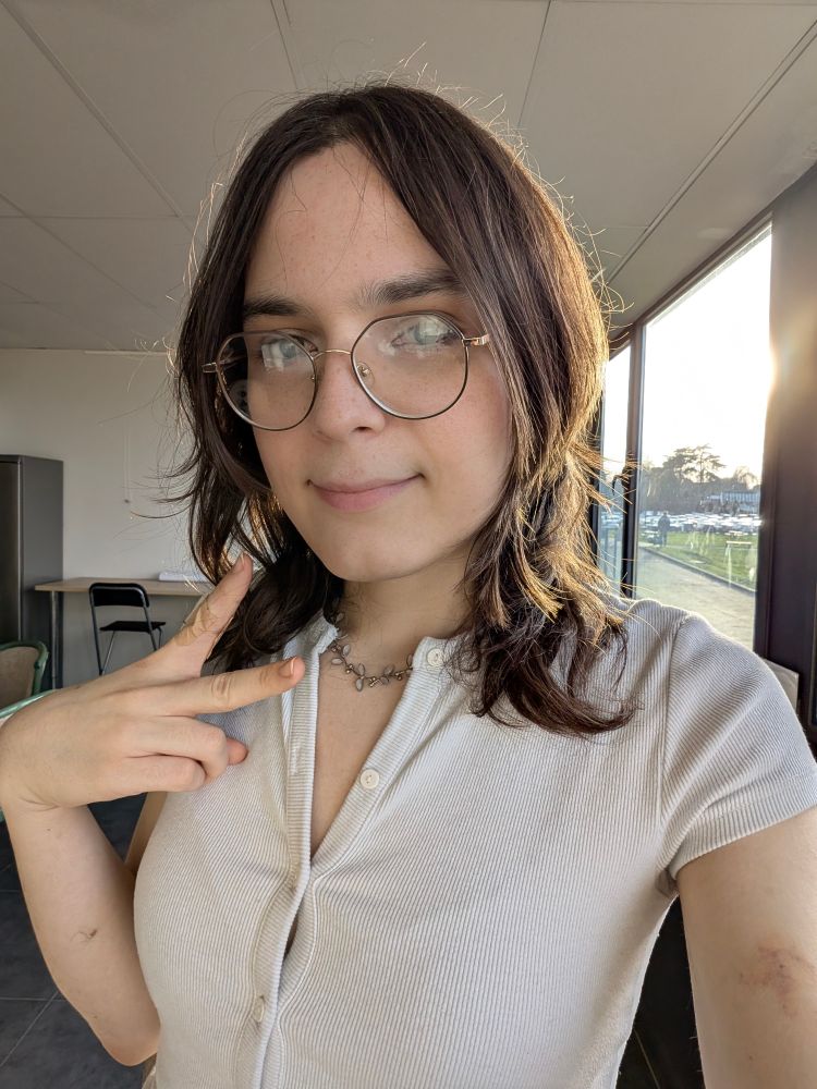 me standing in a room doing a victory sign, the sun behind me is giving my hair some nice rim lighting