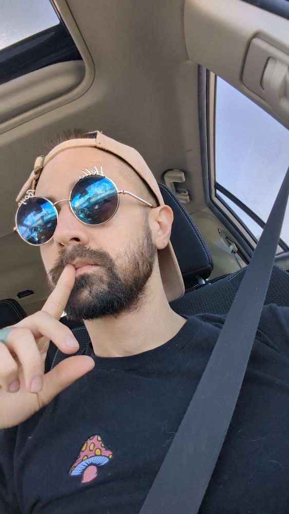 Me in the car in my "hello boys" sunglasses pink hat and black outfit