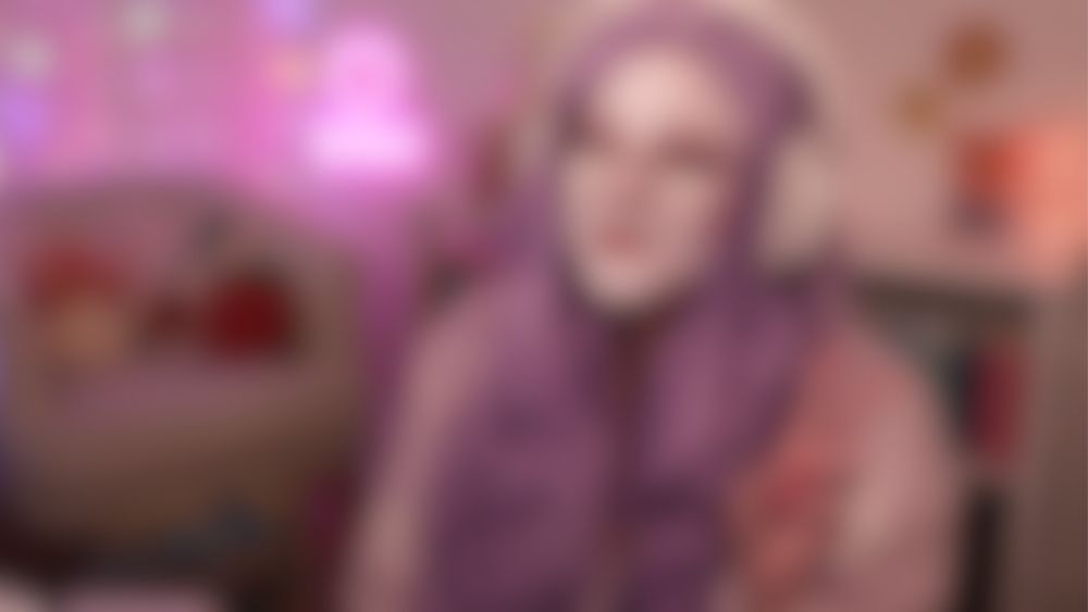 Blurred image of Violet in her stream room in her drag look