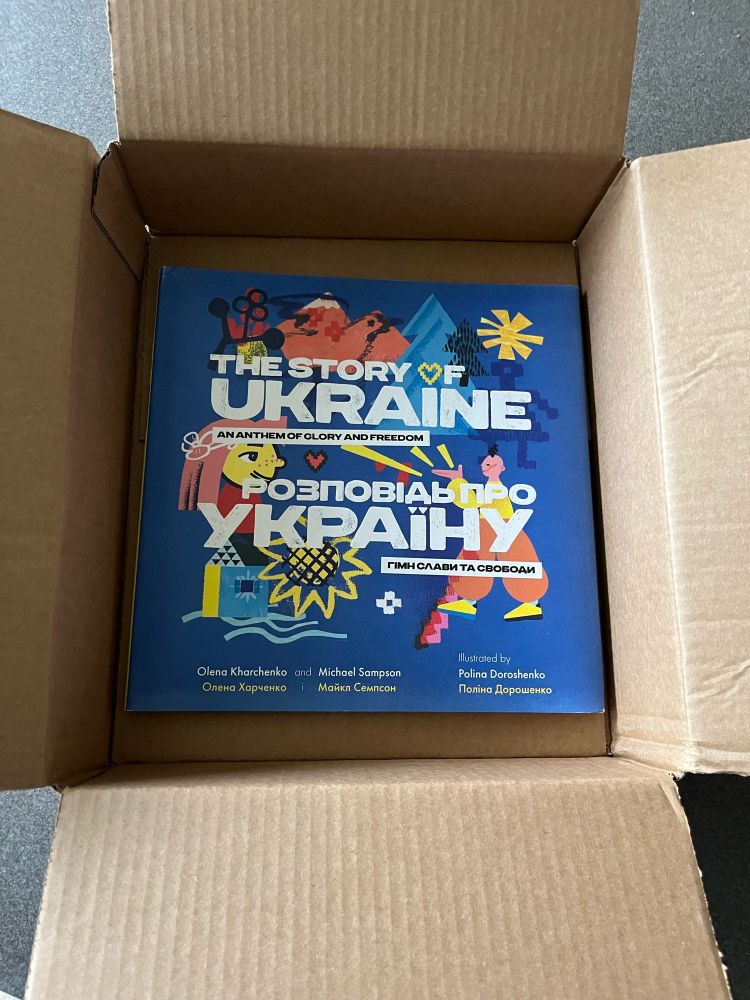 Illustrated book about Ukraine in an open cardboard box