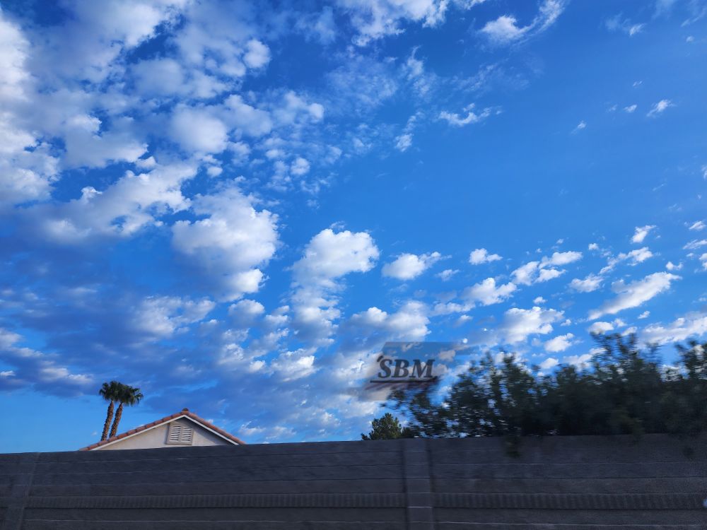Stratocumulus clouds in a curve on a bright blue sky 
