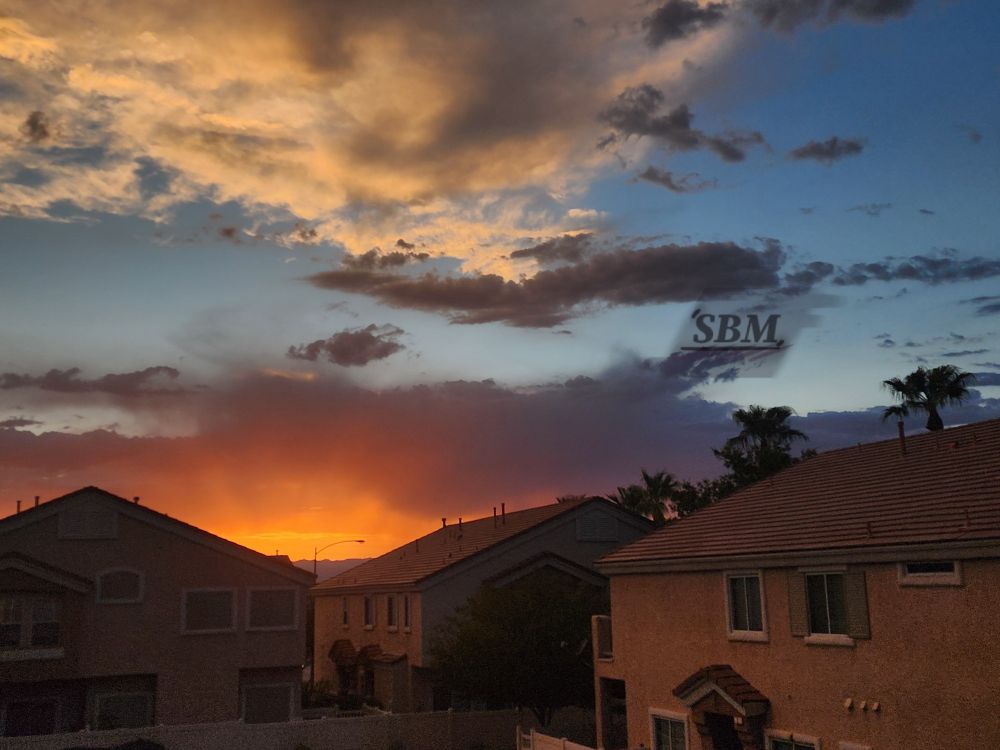 Multicolored sunset of bright gold and orange, muave, light blue, and medium blue with cumulus, stratocumulus, and stratus clouds