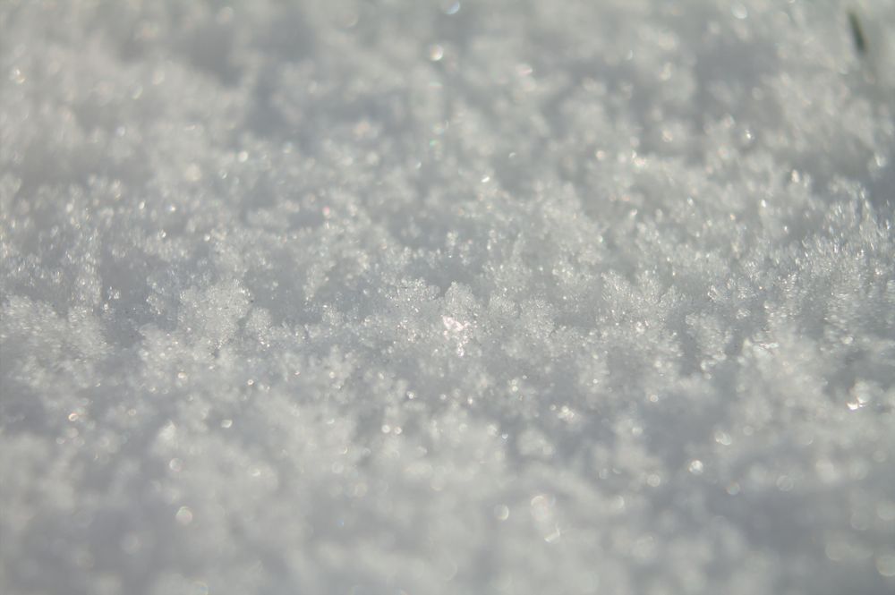 Close-up of snow on a bright and sunny day, the surface is highly textured