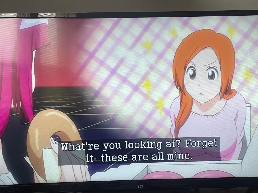 Orihime starring at a girl eating a donut 