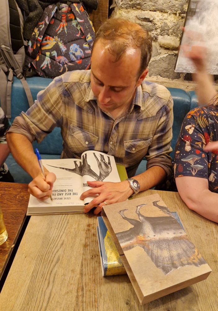 Steve signing books.