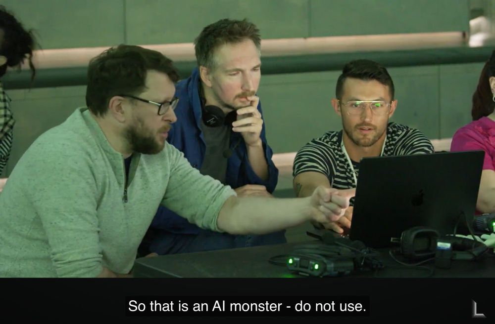 Darren pointing at screen during a technical check at Lightroom, saying "So that is an AI monster - do not use", while working with two other people.