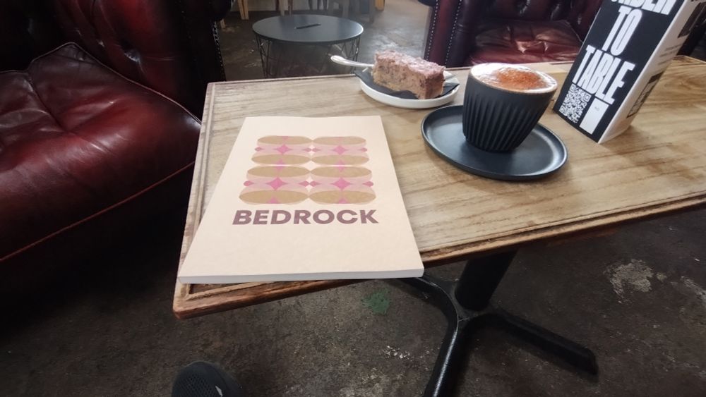 Copy of the Bedrock catalogue with coffee and cake 
