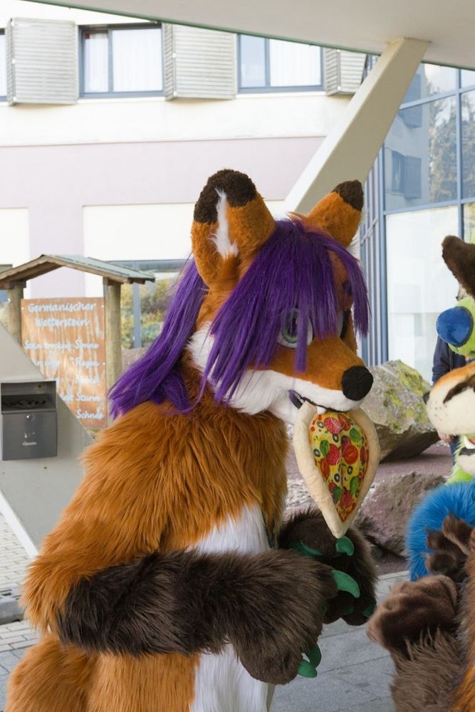 Jarven offering a pizza that hangs out of her snout