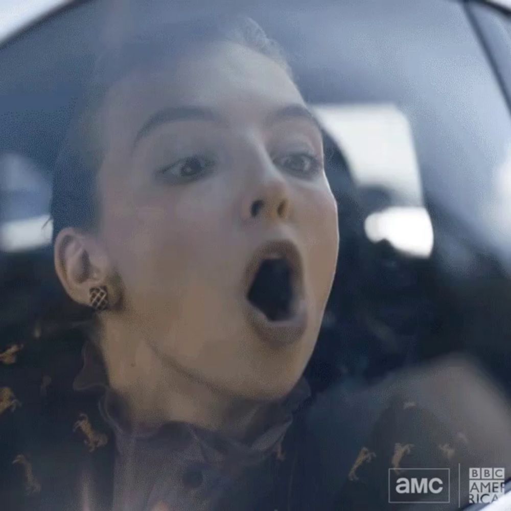 a close up of a woman 's face in a car with a bbc america logo in the corner