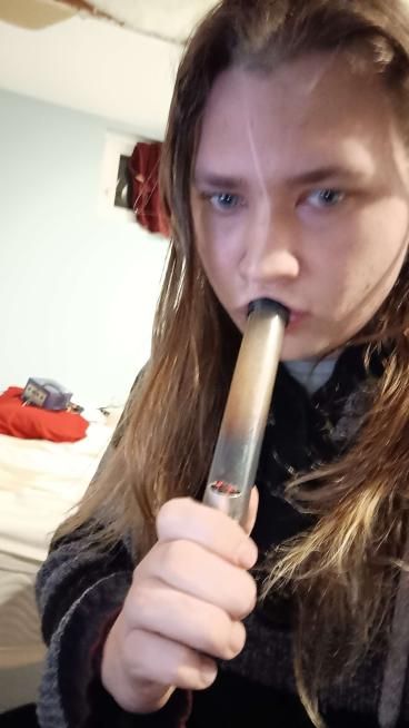 moose smoking weed from a small bong, looking at the camera, the picture is blurry. And I told you to ignore the gamecube!