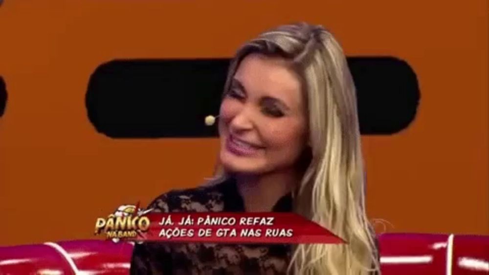 a woman is smiling in front of a banner that says panico