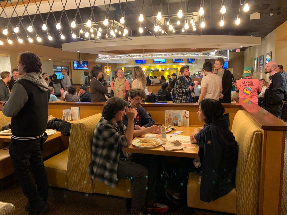 Many members of the game audio community eat and talk at the GADA CPK fundraiser 2024