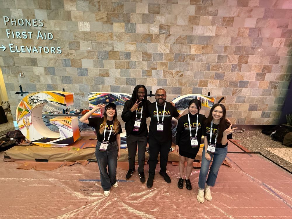 GADA GDC scholars pose in front of a GDC sign