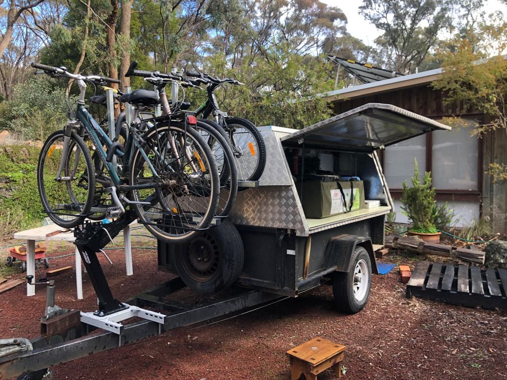 A wing door trailer with bikes loaded on the draw bar ready to start the adventure. 