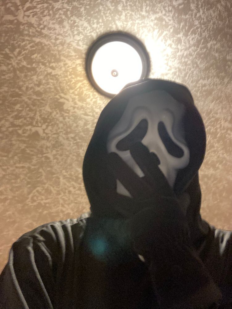 Ghostface covering their mouth in shock 