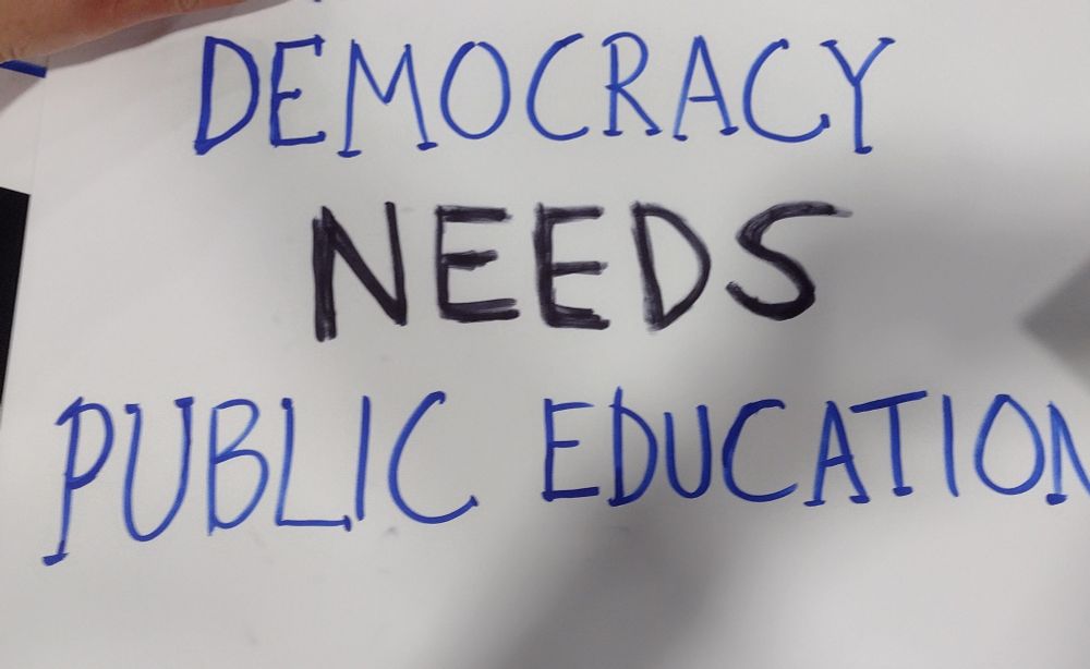 Sign that reads "democracy needs public education"
