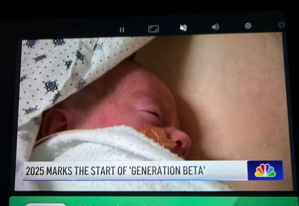 Photo of a taxi TV news story with the headline: “2025 marks the start of Generation Beta”