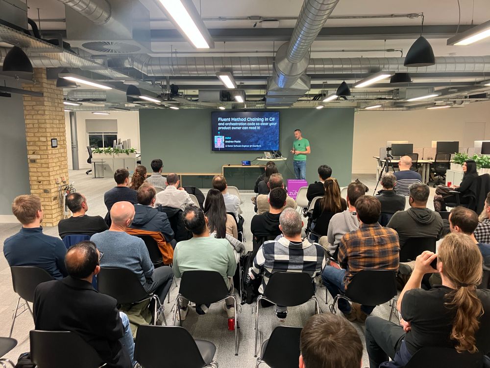 A room full of people watching a presentation