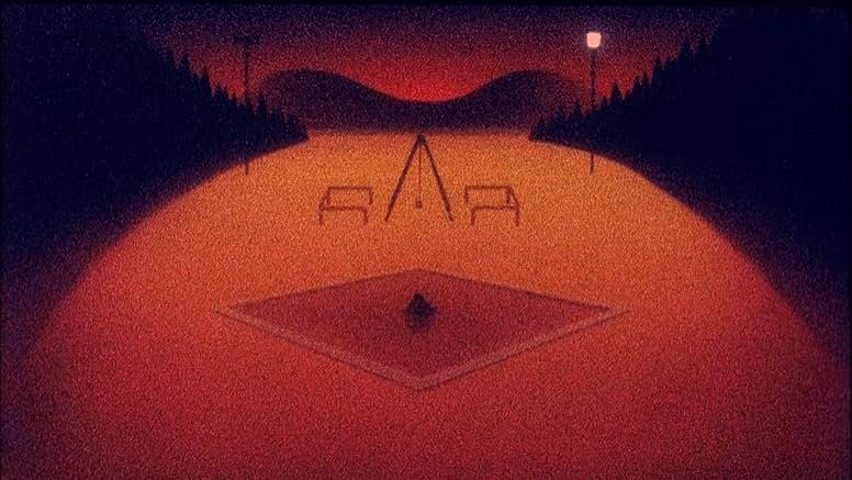 Still image. A children's play area at dusk in orange and black.