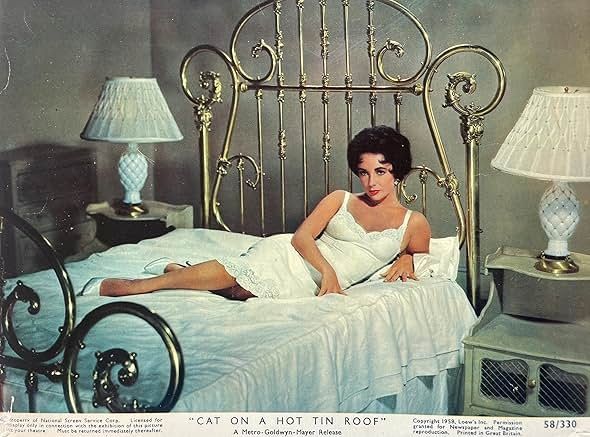 Lobby card. Elizabeth Taylor on that bed again looking sultry in a white dress.