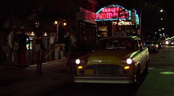 Still image. Yellow taxi drives past the Variety Theatre.