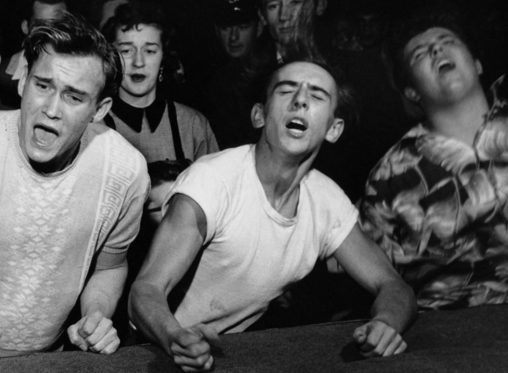 cropped photo from a big jay mcneely performance. 3 white boys freaking the fuck out at the edge of a stage.