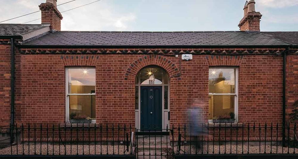 Exterior shot of a red brick terraced single storey home in Dublin