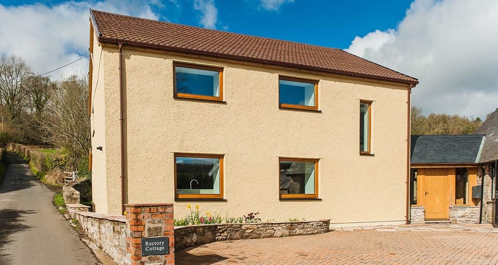 Image shows a detached house in the Brecon Beacons that has been retrofitted to the Enerphit standard