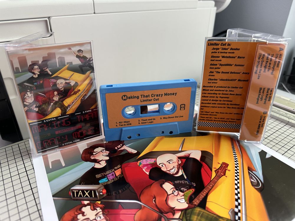 A blue cassette with a yellow label that says "Making That Crazy Money" by Limiter Cut, which consists of the set list from the AGDQ 2025 Crazy Taxi with Live Backing Band run. Beneath it is a large print of the album art of the band members in a roofless taxi, with 2dos hailing the cab from behind. On its left is a cassette case with the album art as well as 'Making That Crazy Money' stylized like a taximeter. To its right is the other side of the case, which has the track list as well as production credits.