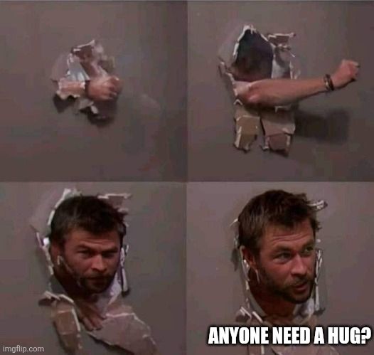 A man punching a hole in a wall then sticking his face through to ask if anyone needs a hug
