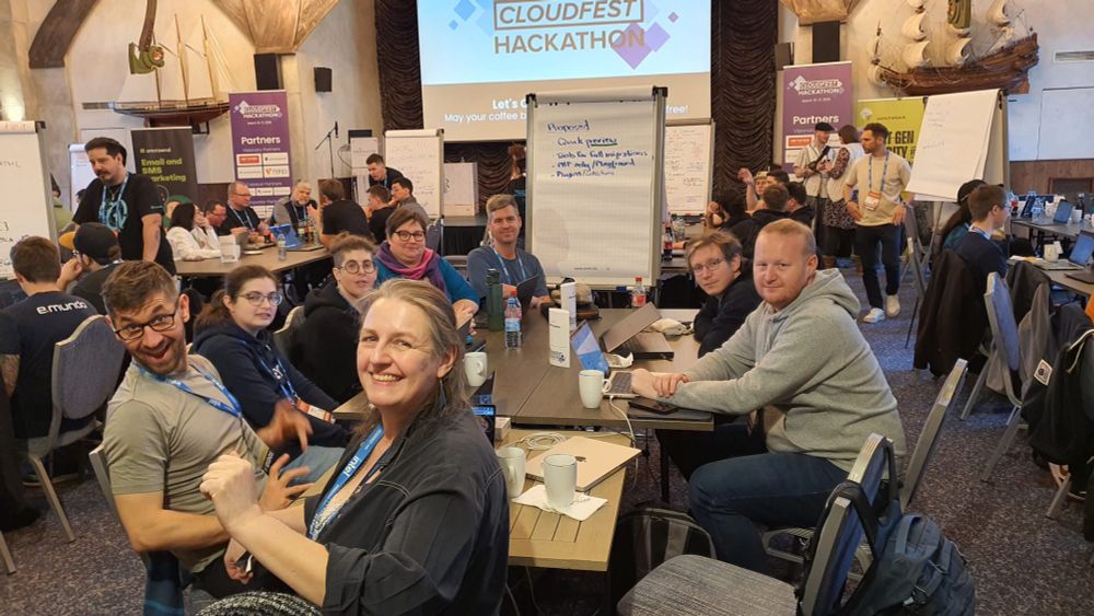 CMSFreedom team, with 8 people at the Hackathon project table