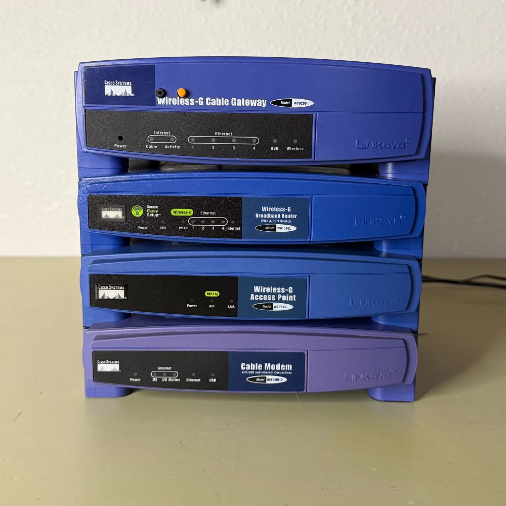 A stack of blue linksys router cases pictured from the front
