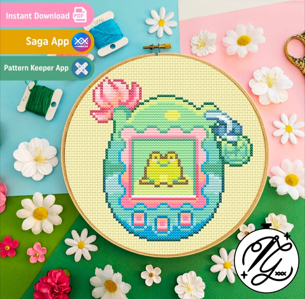 A crossstitch pattern of a frog Tamagotchi. Art by berrycutepixels, stitch pattern by Gitch Stitch AU