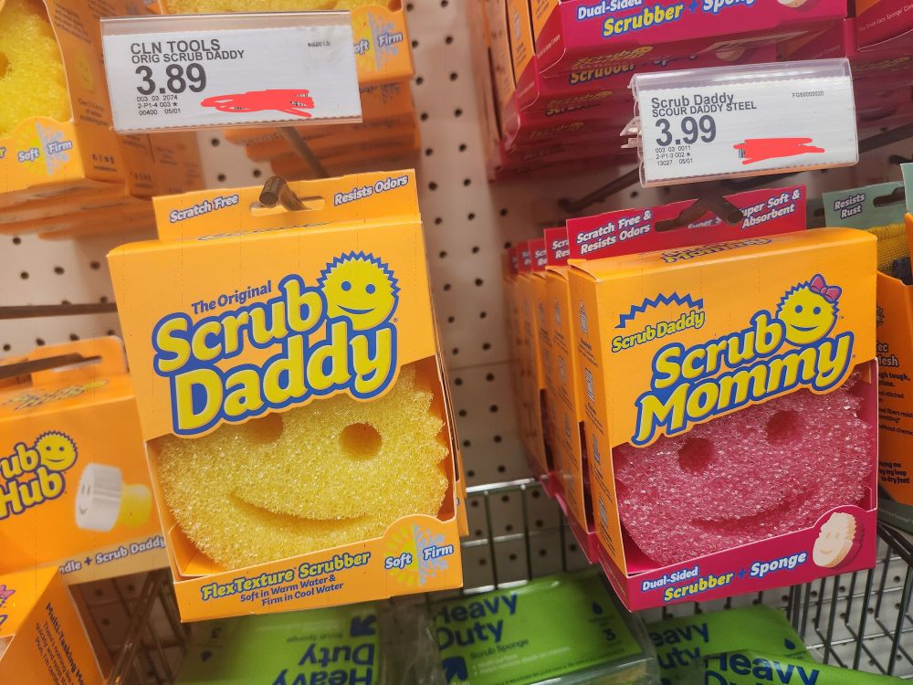 A photo at a store of two sponges: a pink "sponge mommy" and yellow "sponge Daddy" with the sponge mommy being 10 cents more than the sponge daddy
