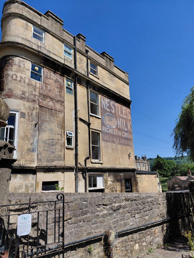Building in Bath showing a painted advertisement for Nestles Milk, 'richest in cream'.